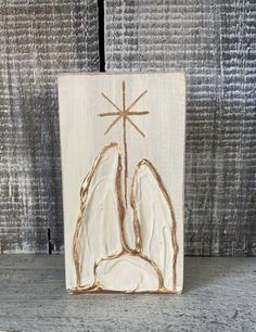 a wooden plaque with an image of the crucifix on it