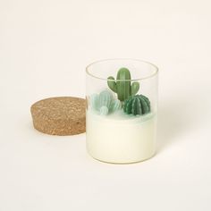 a glass filled with milk next to a cork coaster