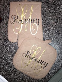 two personalized oven mitts sitting on top of a counter