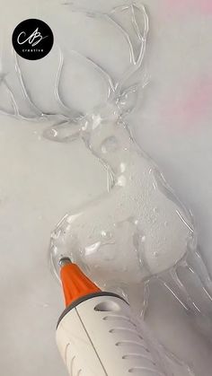 an orange and white blow dryer sitting on top of a table next to a deer head