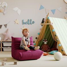 a baby sitting on a green bean bag chair next to a teepee tent and wooden blocks