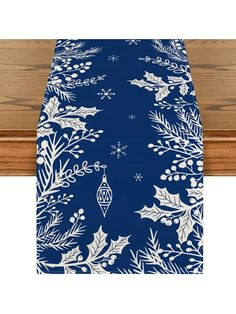 a blue and white christmas table runner