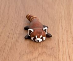 a toy animal laying on top of a wooden table