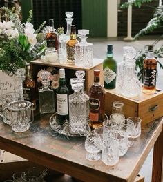 several bottles and glasses on a wooden table