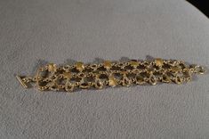 I am offering this fabulous vintage yellow gold tone bracelet. This piece is truly gorgeous, and it has the following features: * beautiful vintage bracelet * yellow gold tone * glass stone * amber * etched * toggle closure * 7 inches in length This is a fantastic and classic piece. There is tons of sparkle and shine with this piece. It will beautifully complement your upcoming fashion season. Buyer pays all shipping and handling. 11/06 Stud Style, Toggle Bracelet, Vintage Bracelet, Brooch Jewelry, Rhinestone Studs, Genuine Turquoise, Fashion Seasons, Vintage Bracelets, Art Deco Style