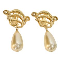 This is part of Chairish’s Costume Jewelry assortment.  A rare fabulous pair of gold-plate oversize Karl Lagerfeld (1980s) open work glass pearl drop clip back earrings Signed,"KL.script, never worn. The photos speak for themselves. They truly are Exquisite.  I have been collecting vintage brand name costume jewelry over 40 years... they are kept in a secure environment ...hence the excellent condition...Stunning earrings.. a must have  Enjoy your purchase and wear them in the best of health.  A Formal Gold Clip-on Earrings With Pearl Drop, Formal Gold-tone Drop Clip-on Earrings, Formal Gold Pearl Drop Clip-on Earrings, Gold Pearl Drop Clip-on Earrings For Formal Occasions, Vintage Gold-plated Hallmarked Earrings, Gold-plated French Hook Drop Earrings, Luxury Vintage Yellow Gold Pearl Earrings, Vintage Karl Lagerfeld, Luxury Vintage Drop Clip-on Earrings