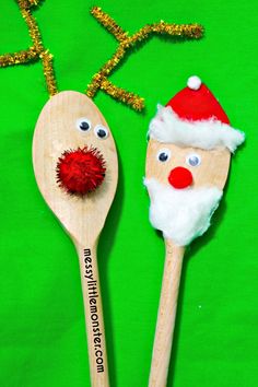 two wooden spoons decorated like santa claus and rudolph the red nose reindeer on green background