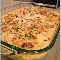 a casserole dish with mushrooms, cheese and sauce in a glass baking dish