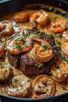 a skillet with shrimp and steak covered in gravy