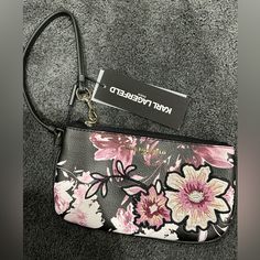 Karl Lagerfeld Floral Wristlet Pouch Brand New With Tags Zipper Closure Wristlet Strap Gold Logo Silver Hardware Floral Embroidered Outlines Rounded Corners Spacious Interior With Pocket 4.5 Inches Tall 7.5 Inches Wide Evening Bags With Wrist Strap, Daily Use Clutch With Silver-tone Hardware, Silver-tone Hardware Clutch For Daily Use, Karl Lagerfeld Purse, Linen Handbags, Karl Lagerfeld Bags, Wristlet Pouch, Denim Shoulder Bags, Black Wristlet