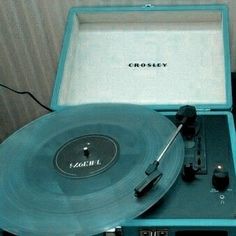 an old record player sitting on top of a table