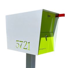 a green and white mailbox with the number 521 on it