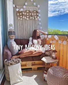 a woman sitting on top of a couch next to a window