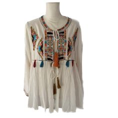 Beautifully Embroidered 40% Cotton, 60% Rayon Super Lightweight Swingy Jacket. More Like Cover For The Hot Summer Days. Relaxed Fit. Exclusive Beads Embellishments At The Front. Unlined, Tassel Detailing, Long Sleeves, Tie Closure At Front. Super Bohemian Style, Perfect For Hot Weather . Hand Wash Cold. White Color Winter Long Sleeve Tops With Tassels, Bohemian Long Sleeve Tops With Geometric Embroidery, White Long Sleeve Top With Intricate Embroidery, White Long Sleeve Tops With Intricate Embroidery, Long Sleeve Tops With Tassels For Fall, Long Sleeve Blouse With Geometric Embroidery, Fall Tops With Multicolor Embroidery And Embroidered Hem, Multicolor Embroidered Long Sleeve Summer Outerwear, Spring Long Sleeve Blouse With Embroidery