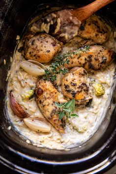 chicken and rice in a slow cooker with a wooden spoon on the side, ready to be eaten