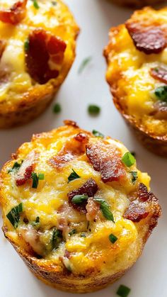 three mini quiche cups with bacon and cheese on the top, sitting on a white plate