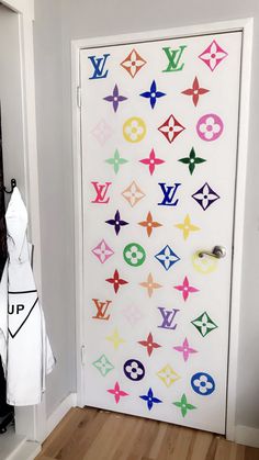 the door is decorated with multicolored louis vuitton stickers on it