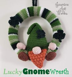 a crocheted christmas ornament hanging on a wall with the words lucky gnome wreath