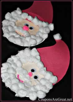 two paper plates with santa claus's face made out of white pom - poms