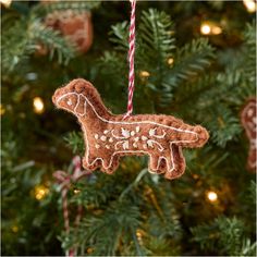 a brown dog ornament hanging from a christmas tree