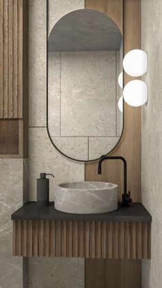 a bathroom with a sink, mirror and lights on the wall above it's counter