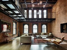 a large living room with high ceilings and wooden floors