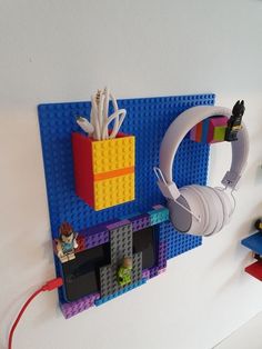 there is a lego wall with headphones on it