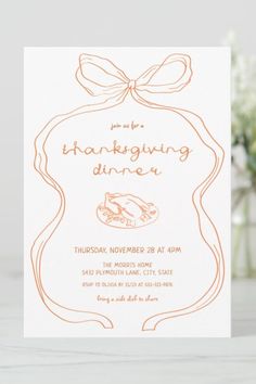 an orange thanksgiving dinner card with a bow on it