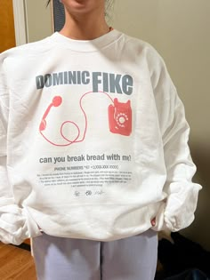 Can you break bread with me? Dominic Fike Phone numbers 90s-inspired band merch sweatshirt, featured lyrics and graphics from the song. Crewneck sweatshirt material is 50/50 cotton and polyester. Each item is uniquely printed and designed by me. Model in the photos is wearing size L as an oversized fit, or would wear size M for regular fit. Also available on: *Lightweight White T shirt *Women's size Cream Tank top Black/Red ink on White Clothing Unisex Sizing, S, M, L, XL Available (Message me f Pleasing Merch, Sweatshirt Graphic, Dominic Fike Phone Numbers, 90s Style Graphic Print Sweatshirt For Fans, White And Black Outfits, Aesthetic Items, Pop Culture Screen Print Sweatshirt For Streetwear, Retro Text Print Sweatshirt For Streetwear, Dominic Fike Merch