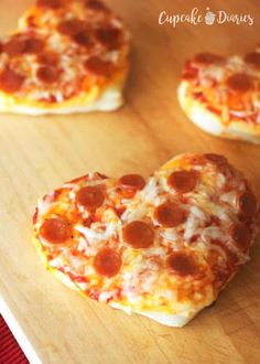 heart shaped pepperoni pizzas on a cutting board