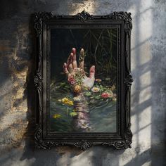 a painting hanging on the side of a wall next to a water fountain with flowers in it