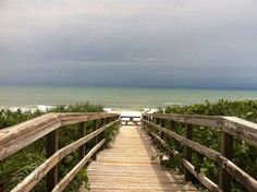 a wooden walkway leading to the beach