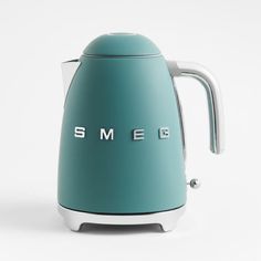 an electric kettle with the word smeg written on it's front and side