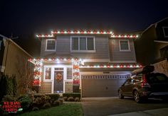 a car parked in front of a house decorated with christmas lights