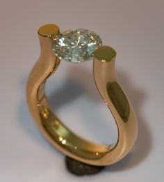 a gold ring with a diamond on it