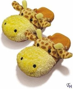 two giraffe slippers are shown on a white surface