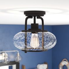 a light fixture in a bedroom with blue walls