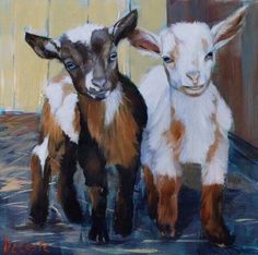 two baby goats standing next to each other