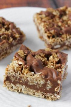 three pieces of chocolate peanut butter granola bars on a plate