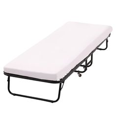 a white cot with black frame and wheels