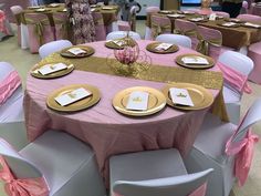 the tables are set with pink and gold linens