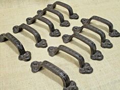 an assortment of old metal handles on a table