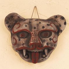 an animal mask hanging on the side of a wall