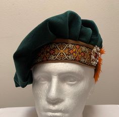 "A new professional quality Renaissance Medieval Tudor Scottish Irish muffin floppy hat. This green flocking velvet floppy hat is embellished with a brocade band and brown and orange feathers. Side medallion will vary in design. Fully lined. New not worn. A great accent for your Medieval Renaissance outfit for your reenactment event, theme party or stage production. Sales final. Will exchange for a different size. Size small has a 22\" band Size medium has a 22 1/2\" band Size large has a 23\" b Medieval Hats, Celtic Green, Medieval Garb, Mad Hatter Hat, Irish Celtic, Costume Cosplay, Green Suede, Fantasy Clothing, Mens Costumes