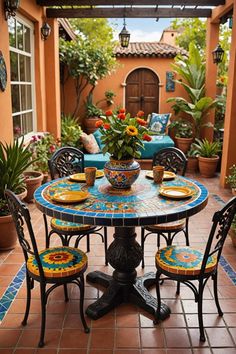 an outdoor table with four chairs and a potted plant in the center on a tiled patio