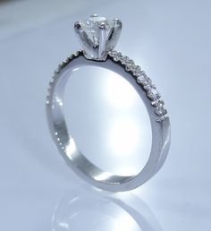 a diamond ring is shown on a white surface