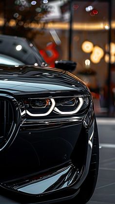 the front end of a black bmw car