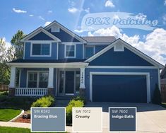 a blue house with white trim and two garages on each side, the words b & k painting above it