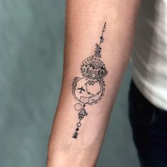 a woman's arm with a tattoo on it that has a clock and arrows