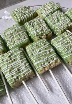 there are many green and white treats on sticks